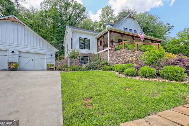 533 Ledford Rd, Dillard, GA 30537 - view of front facade with a front yard, a garage, concrete driveway, a balcony, and stone siding