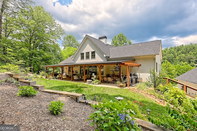533 Ledford Rd, Dillard, GA 30537 - back of house with a patio, a chimney, a shingled roof, and a lawn