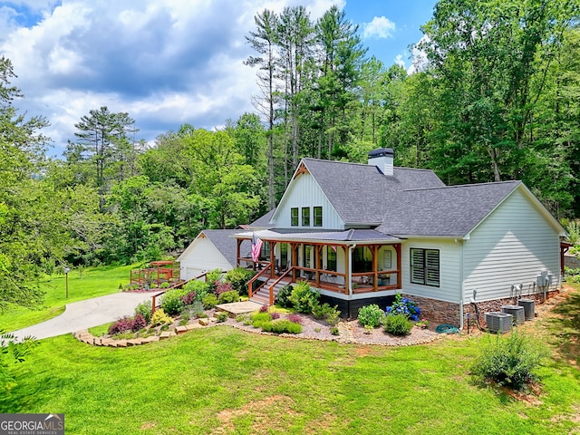 533 Ledford Rd, Dillard, GA 30537 - view of front of house featuring a porch, a shingled roof, a front lawn, a chimney, and a forest view