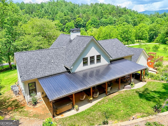 533 Ledford Rd, Dillard, GA 30537 - view of front of property featuring a metal roof, a wooded view, a chimney, a patio, and a front lawn