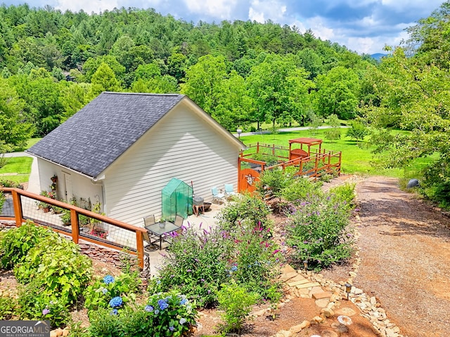 533 Ledford Rd, Dillard, GA 30537 - view of side of property with a shingled roof and a wooded view