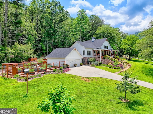 533 Ledford Rd, Dillard, GA 30537 - view of front of house featuring an outbuilding, concrete driveway, a wooded view, and an attached garage