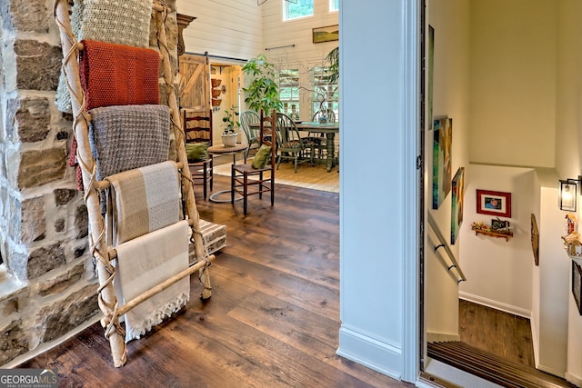 533 Ledford Rd, Dillard, GA 30537 - sitting room with hardwood / wood-style floors, a barn door, wood walls, and a high ceiling