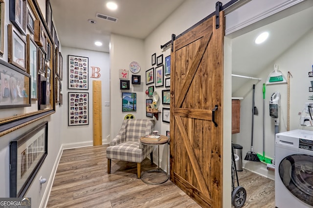 533 Ledford Rd, Dillard, GA 30537 - washroom featuring washer / dryer, a barn door, light wood-style floors, and recessed lighting