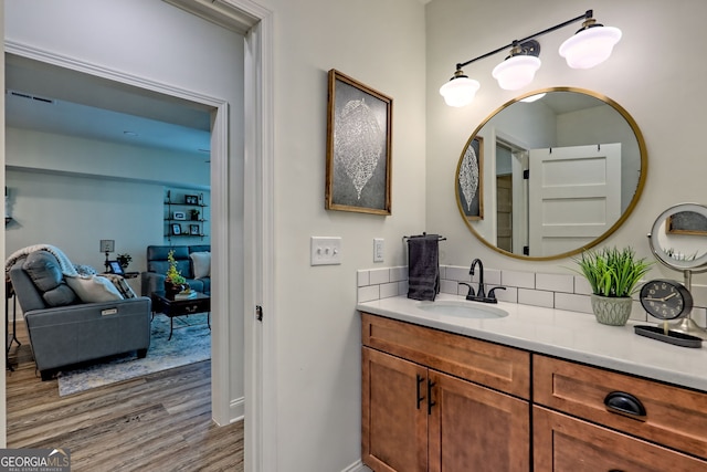 533 Ledford Rd, Dillard, GA 30537 - bathroom with wood finished floors, vanity, and backsplash