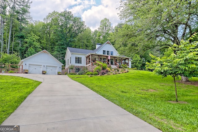 533 Ledford Rd, Dillard, GA 30537 - view of front of house with a detached garage, an outbuilding, a front yard, a chimney, and a porch