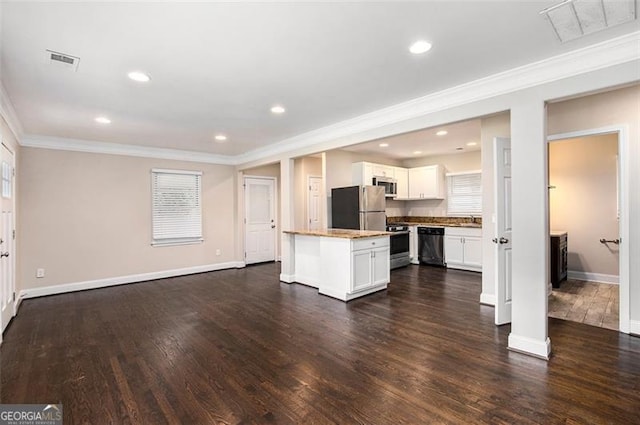 1856 Austell, Marietta, GA 30060 - kitchen featuring crown molding, stainless steel appliances, white cabinets, dark wood-style flooring, and a center island