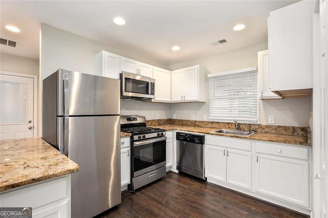 1856 Austell, Marietta, GA 30060 - kitchen with stainless steel appliances, white cabinets, light stone counters, and recessed lighting