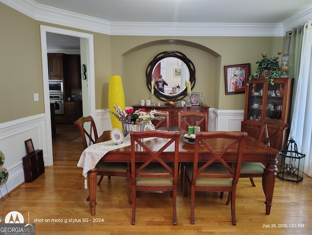 1292 Hidden Spirit Trl, Lawrenceville, GA 30045 - dining area featuring crown molding, wainscoting, light wood finished floors, and a decorative wall