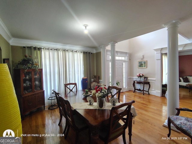 1292 Hidden Spirit Trl, Lawrenceville, GA 30045 - dining area featuring decorative columns, ornamental molding, wood finished floors, and a wainscoted wall