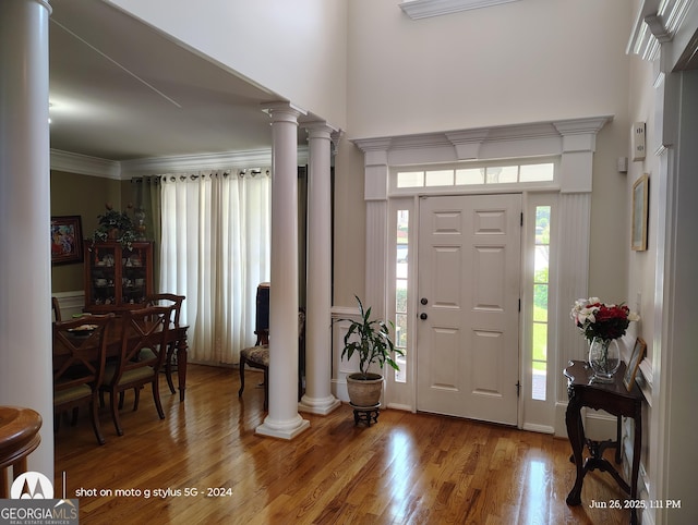 1292 Hidden Spirit Trl, Lawrenceville, GA 30045 - foyer featuring wood finished floors, decorative columns, a towering ceiling, and crown molding