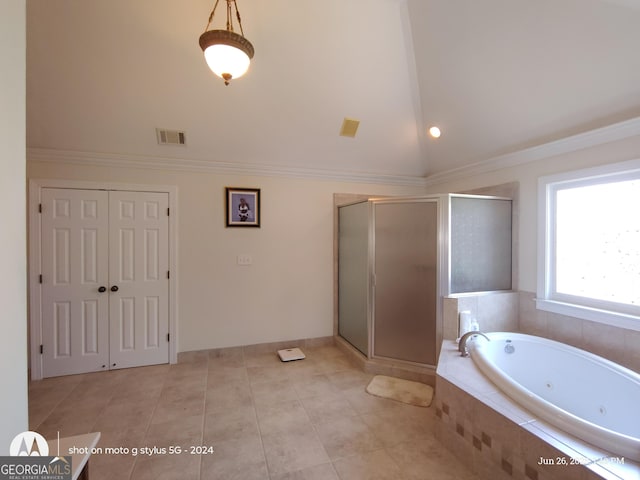 1292 Hidden Spirit Trl, Lawrenceville, GA 30045 - bathroom featuring lofted ceiling, a jetted tub, a shower stall, and tile patterned flooring