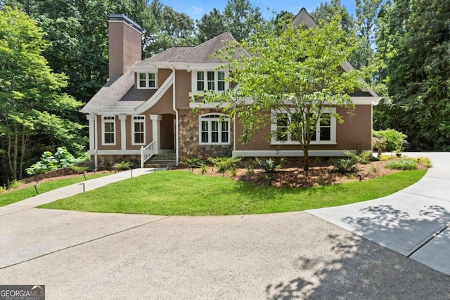5455 Malone Ct, Powder Springs, GA 30127 - english style home featuring a chimney, stucco siding, a front yard, stone siding, and concrete driveway