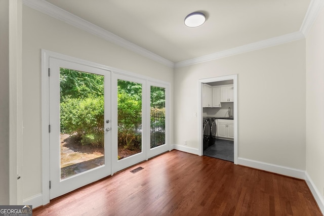 5455 Malone Ct, Powder Springs, GA 30127 - unfurnished bedroom featuring access to outside, dark wood finished floors, ornamental molding, connected bathroom, and independent washer and dryer