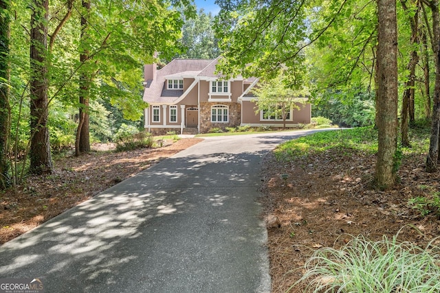 5455 Malone Ct, Powder Springs, GA 30127 - tudor-style house with stone siding, driveway, stucco siding, and a chimney