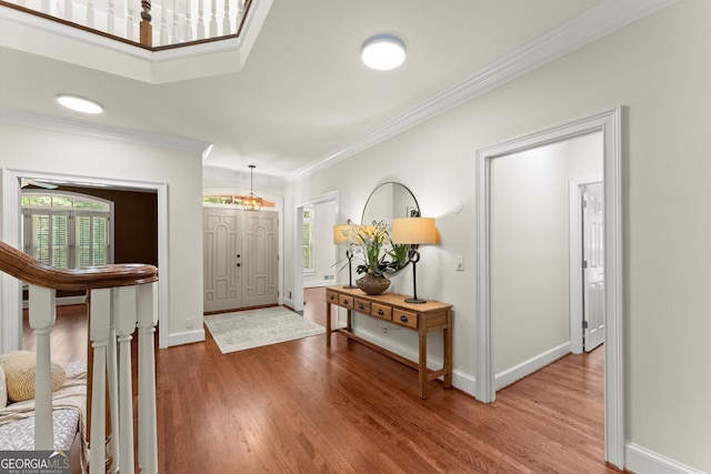 5455 Malone Ct, Powder Springs, GA 30127 - foyer featuring wood finished floors, crown molding, and a chandelier