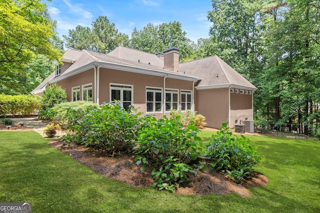 5455 Malone Ct, Powder Springs, GA 30127 - back of house featuring stucco siding, a chimney, and roof with shingles