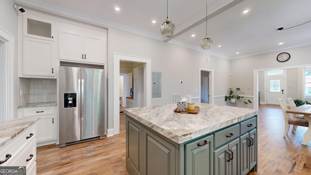 1437 18th St, Columbus, GA 31901 - kitchen with stainless steel fridge, white cabinetry, light wood-style floors, a kitchen island, and electric panel