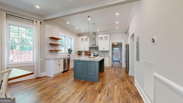 1437 18th St, Columbus, GA 31901 - kitchen with appliances with stainless steel finishes, wall chimney range hood, white cabinetry, crown molding, and plenty of natural light
