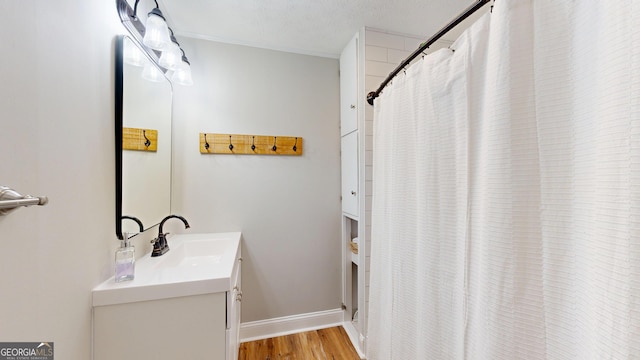 1437 18th St, Columbus, GA 31901 - full bathroom with vanity, wood finished floors, a shower with curtain, and crown molding
