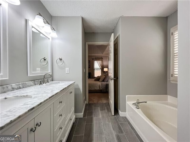1361 Chatley Way, Woodstock, GA 30188 - full bath featuring double vanity, a garden tub, a textured ceiling, ensuite bathroom, and wood tiled floors