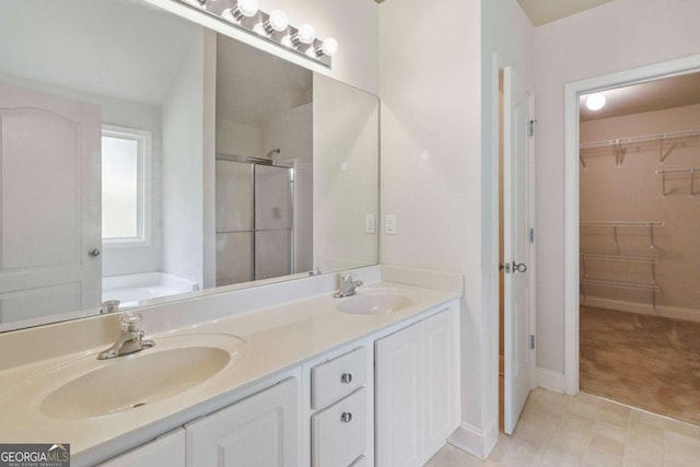 154 Ashebrooke Way, Jefferson, GA 30549 - bathroom featuring a stall shower, double vanity, a walk in closet, and a garden tub