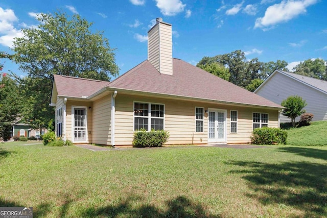 154 Ashebrooke Way, Jefferson, GA 30549 - back of property with french doors, a chimney, a yard, and roof with shingles