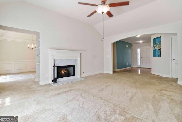 154 Ashebrooke Way, Jefferson, GA 30549 - unfurnished living room with ceiling fan, carpet floors, vaulted ceiling, arched walkways, and a premium fireplace
