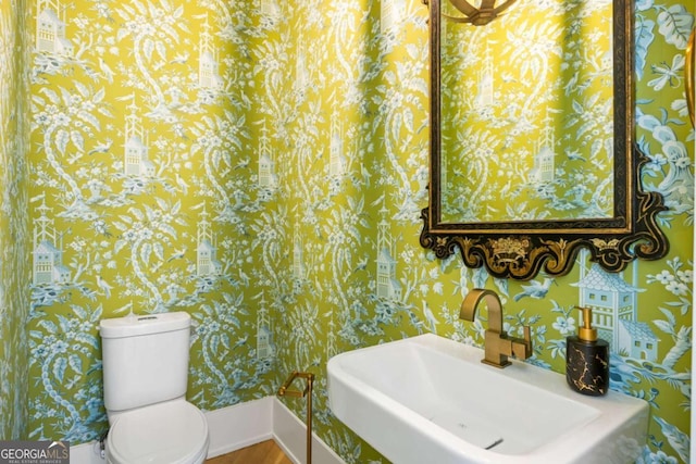 11277 Serenbe Ln, Chattahoochee Hills, GA 30268 - half bathroom with wallpapered walls and wood finished floors