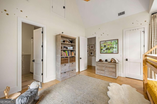 11277 Serenbe Ln, Chattahoochee Hills, GA 30268 - bedroom featuring light wood-style flooring, a high ceiling, and ensuite bath