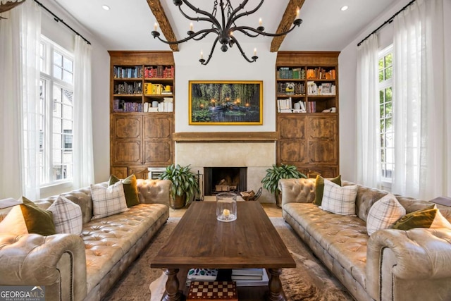 11277 Serenbe Ln, Chattahoochee Hills, GA 30268 - living area featuring plenty of natural light, beam ceiling, built in features, a chandelier, and a high end fireplace