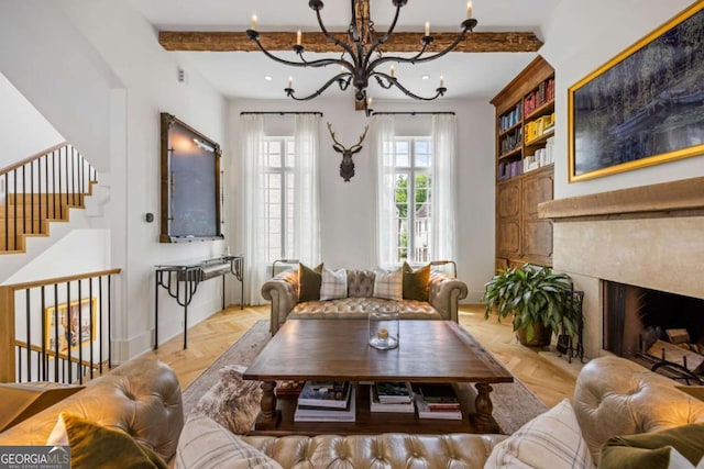 11277 Serenbe Ln, Chattahoochee Hills, GA 30268 - living room featuring a premium fireplace, a chandelier, beamed ceiling, and stairs