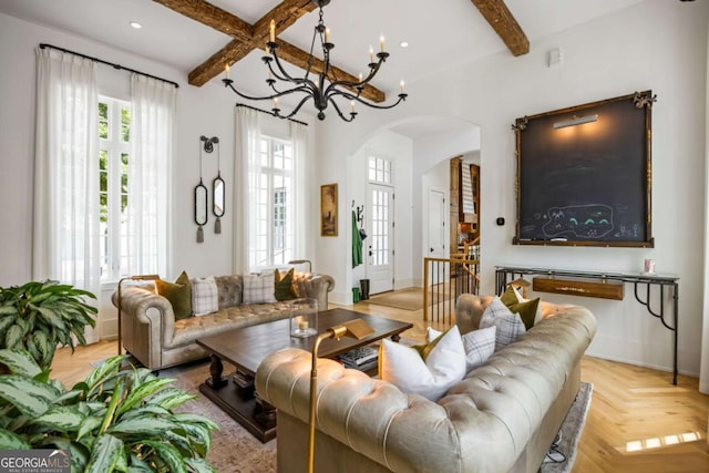 11277 Serenbe Ln, Chattahoochee Hills, GA 30268 - living area featuring arched walkways, beamed ceiling, a chandelier, and recessed lighting