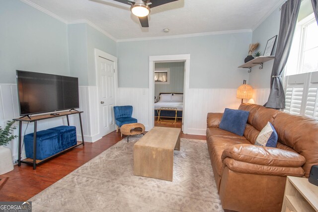 2200 3rd Ave, Opelika, AL 36801 - living area featuring a wainscoted wall, wood finished floors, a ceiling fan, and ornamental molding