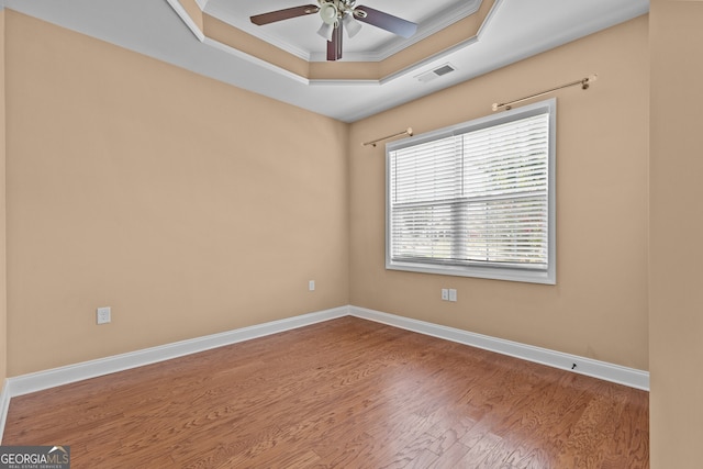 3209 Telhurst Way, Buford, GA 30519 - empty room with a ceiling fan, wood finished floors, crown molding, and a tray ceiling