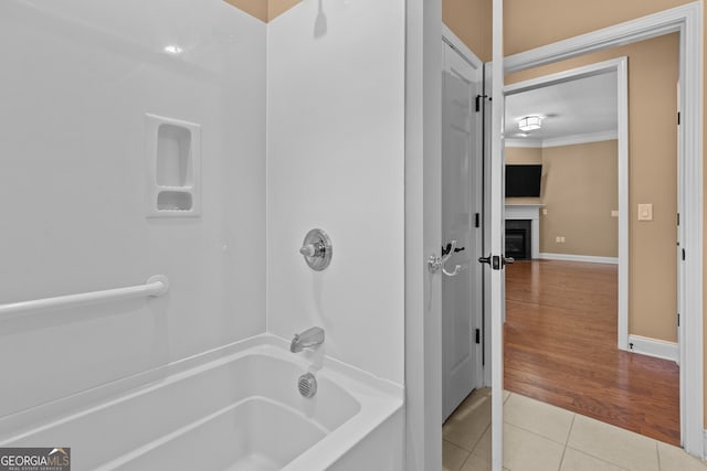 3209 Telhurst Way, Buford, GA 30519 - full bath featuring tile patterned floors, tub / shower combination, a fireplace, and crown molding