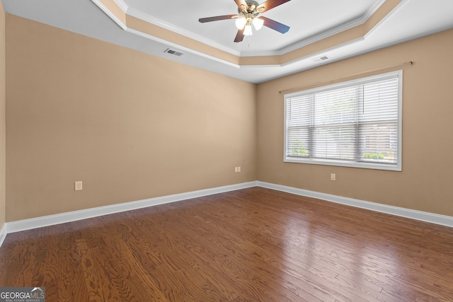 3209 Telhurst Way, Buford, GA 30519 - empty room featuring a raised ceiling, ornamental molding, dark wood-style floors, and ceiling fan