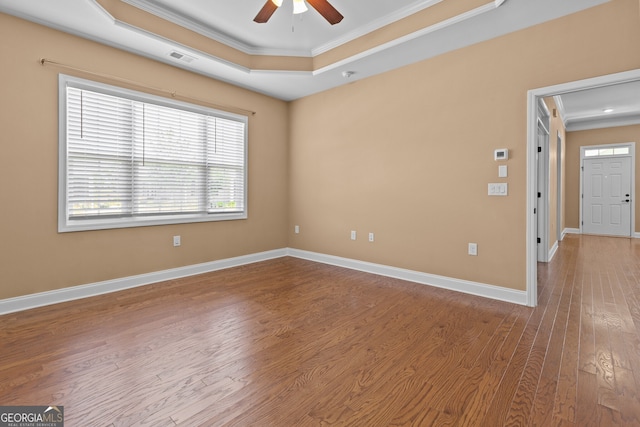 3209 Telhurst Way, Buford, GA 30519 - empty room with crown molding, ceiling fan, a tray ceiling, and wood finished floors