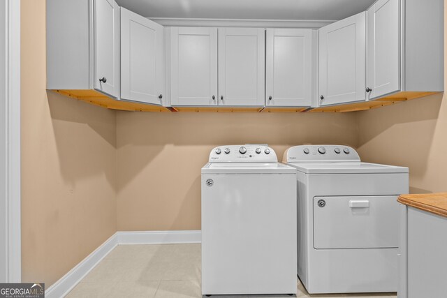 3209 Telhurst Way, Buford, GA 30519 - laundry room featuring cabinet space, washing machine and clothes dryer, and light tile patterned floors