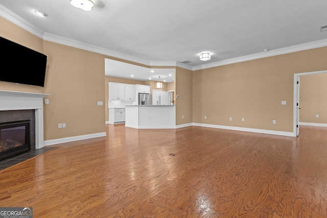 3209 Telhurst Way, Buford, GA 30519 - unfurnished living room with ornamental molding, light wood finished floors, a tile fireplace, and recessed lighting