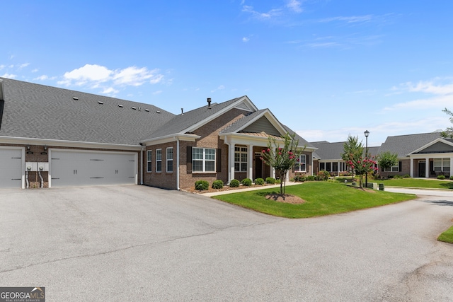 3209 Telhurst Way, Buford, GA 30519 - view of front facade featuring brick siding, driveway, an attached garage, and a front lawn