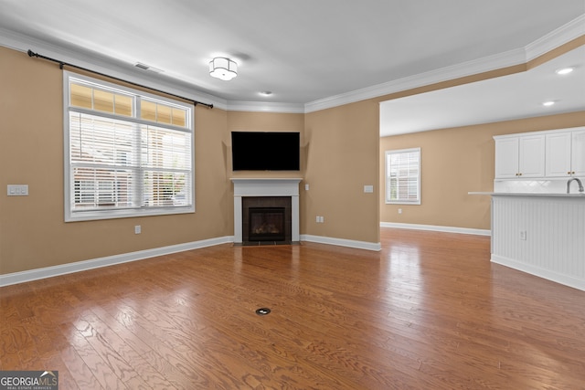 3209 Telhurst Way, Buford, GA 30519 - unfurnished living room with ornamental molding, a tile fireplace, and light wood-style flooring