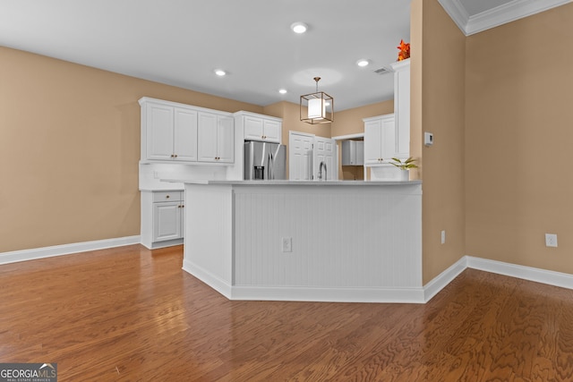 3209 Telhurst Way, Buford, GA 30519 - kitchen with stainless steel fridge with ice dispenser, light wood-type flooring, white cabinetry, recessed lighting, and pendant lighting