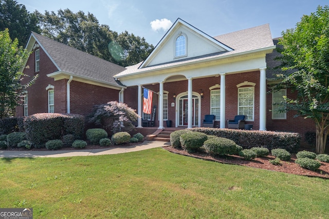 97 Windermere Cir, Newnan, GA 30265 - greek revival house with brick siding, a front yard, covered porch, and a shingled roof