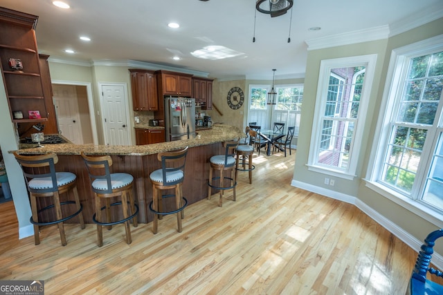 97 Windermere Cir, Newnan, GA 30265 - kitchen featuring stainless steel fridge, ornamental molding, light stone counters, light wood-style floors, and decorative backsplash
