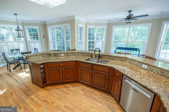 97 Windermere Cir, Newnan, GA 30265 - kitchen with stainless steel dishwasher, light wood-style flooring, plenty of natural light, brown cabinetry, and ornamental molding