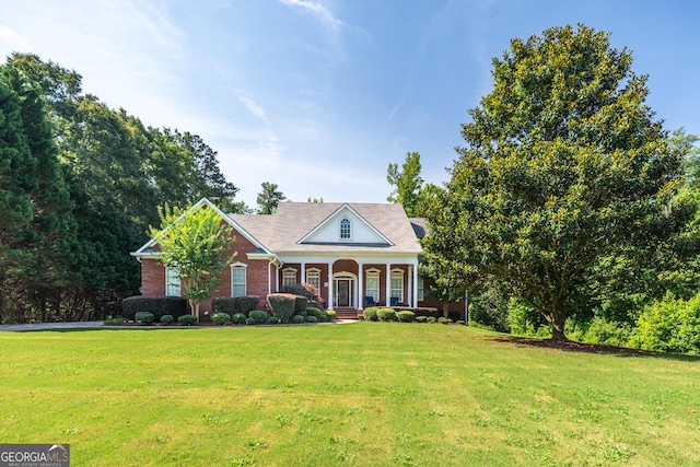 97 Windermere Cir, Newnan, GA 30265 - neoclassical / greek revival house with a porch, a front yard, and brick siding