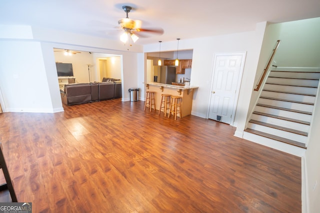 97 Windermere Cir, Newnan, GA 30265 - living room with ceiling fan, dark wood-style flooring, and stairway
