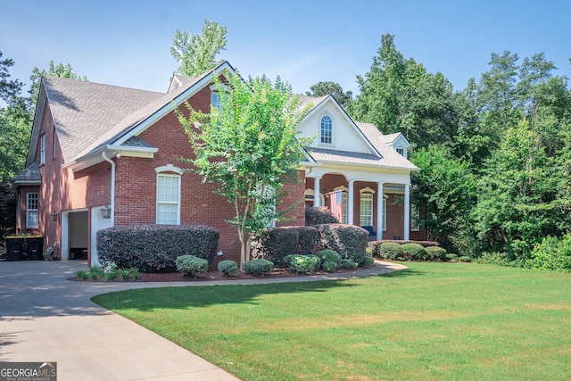 97 Windermere Cir, Newnan, GA 30265 - neoclassical home featuring a garage, a front lawn, brick siding, driveway, and covered porch
