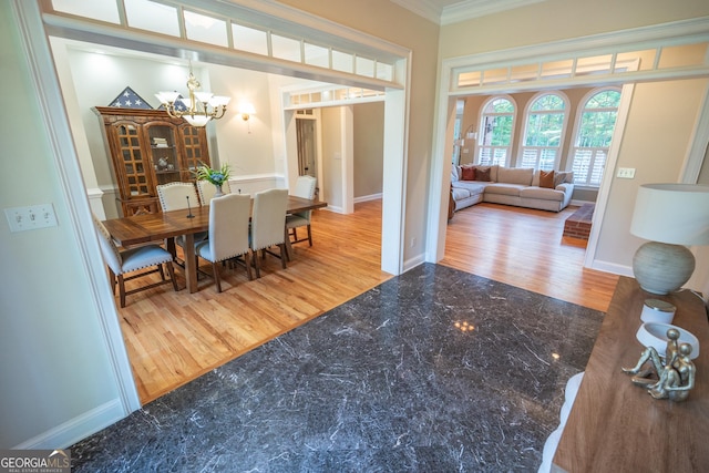 97 Windermere Cir, Newnan, GA 30265 - dining space with crown molding, a chandelier, and wood finished floors
